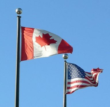"Flags-of-usa-and-canada" by Makaristos - Own work. Licensed under Public Domain via Wikimedia Commons - https://commons.wikimedia.org/wiki/File:Flags-of-usa-and-canada.jpg#/media/File:Flags-of-usa-and-canada.jpg